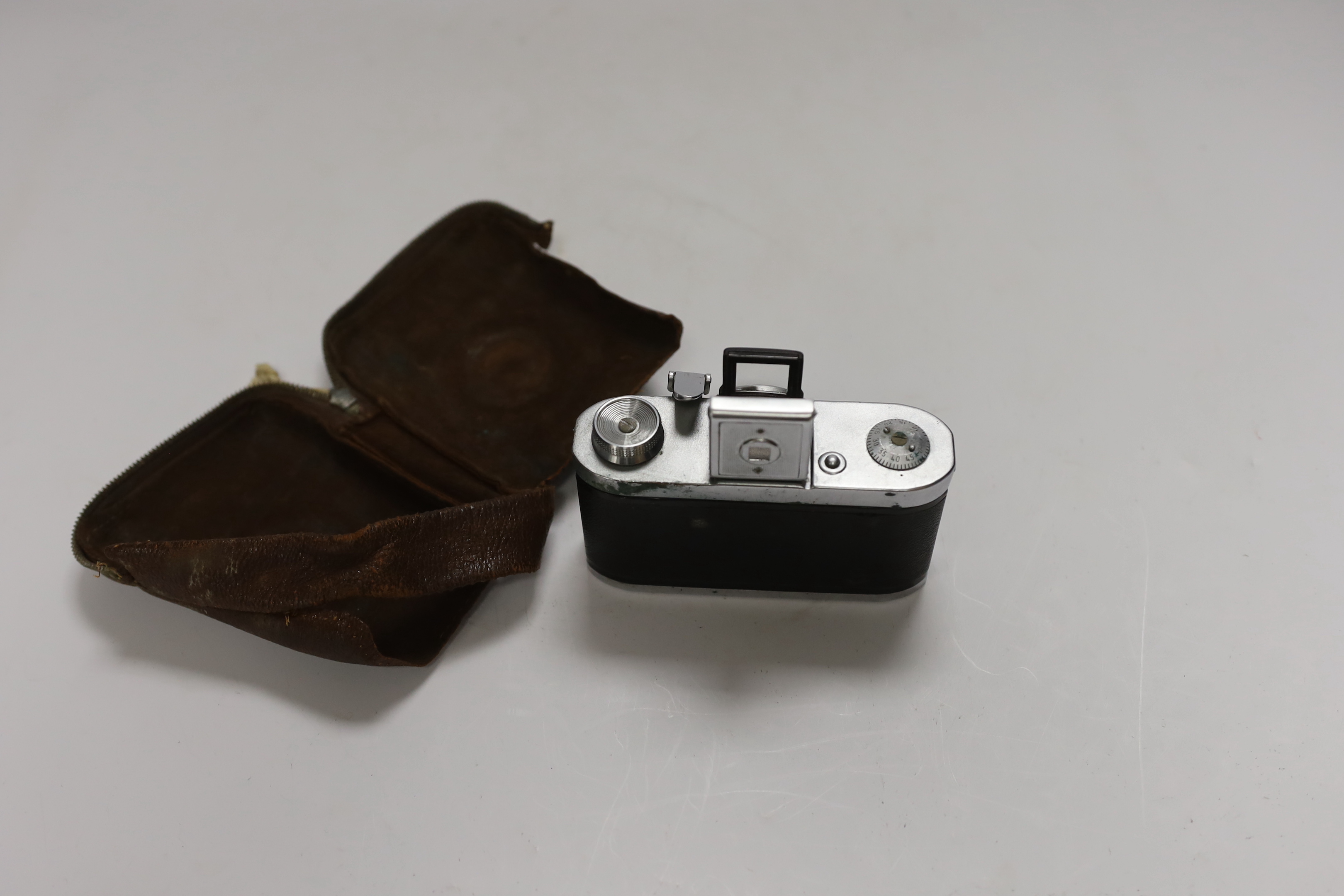 A 1940s Zeiss Ikon Tenax I compact camera, serial no.H87069, in the remains of a leather case